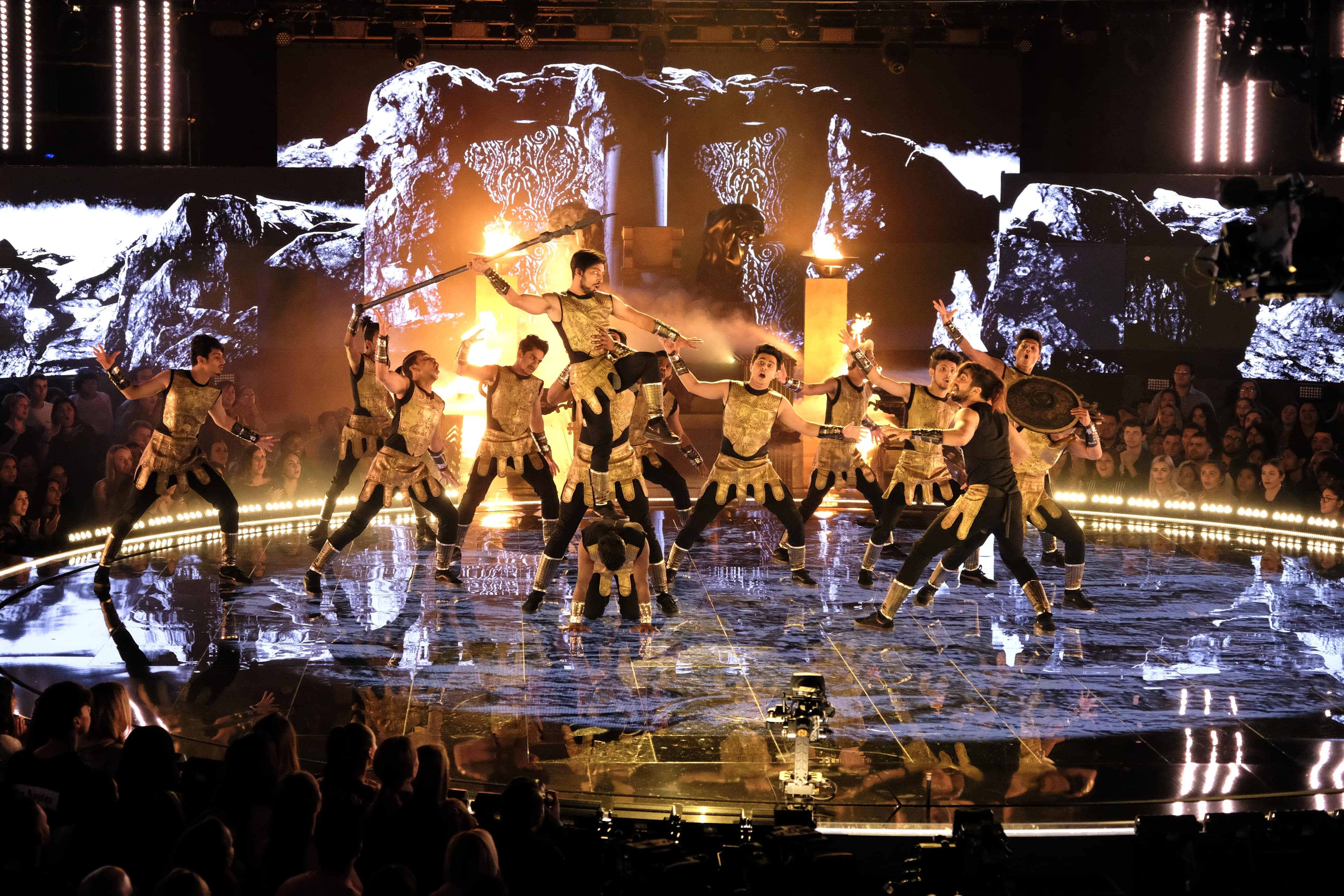 The Kings crew mid-performance with fire and gold costumes