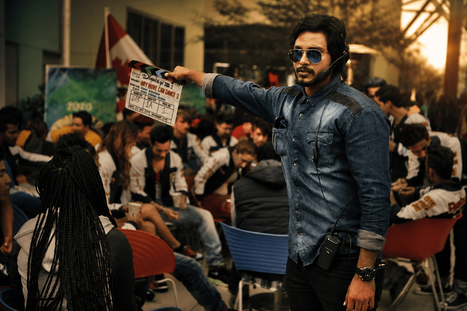 Suresh Mukund directing on set with a clapperboard
